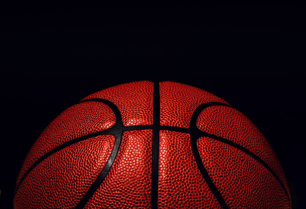 istock basketball ball on black background. 1164019331