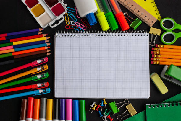 istock Notebook, bright modern minimalist stationery for schoolwork on a black background. Accessories for study. Back to school concept. 1164022458