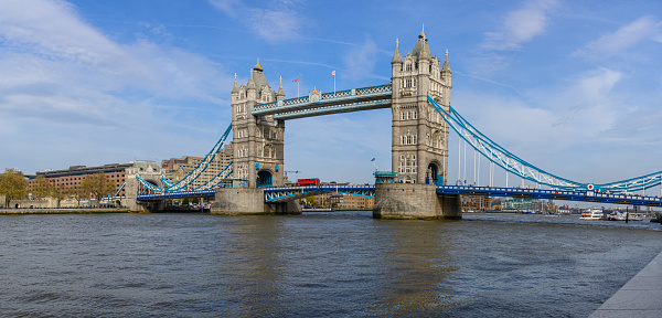 London`s most famous bridge and its two towers over the River Thames and a beautiful cloudy blue sky