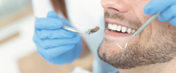 istock Young man at the dentist 1164023735