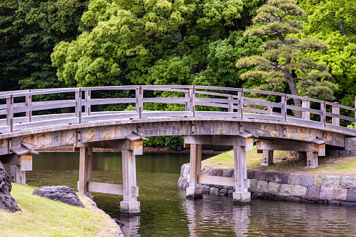 Tokyo, Japan - May 20, 2019: A beautiful bridge in a Japanese garden, in the Hamarikyu Gardens in Tokyo, Japan.