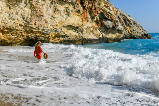 Woman walking among the waves.