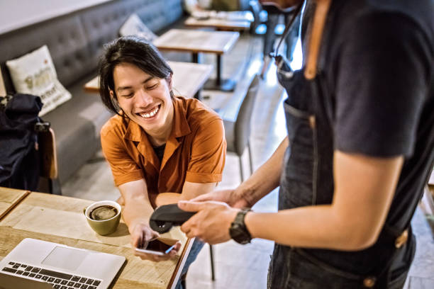 istock Man Using Contactless Payment App On Mobile Phone In Cafe 1164027449