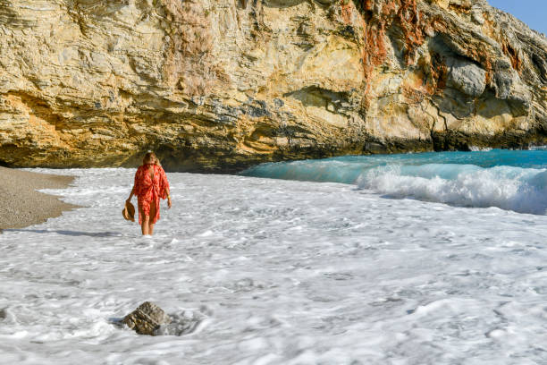 istock Woman walking among the waves. 1164027461