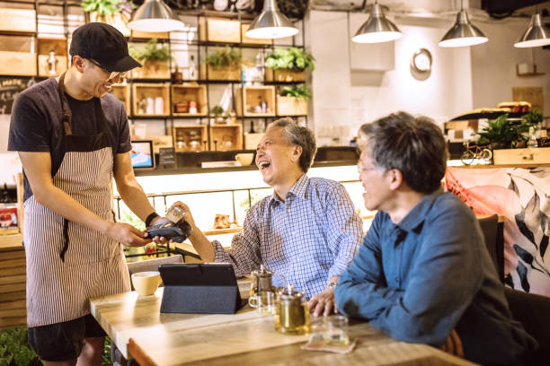istock Senior in cafe paying Contactless 1164027476