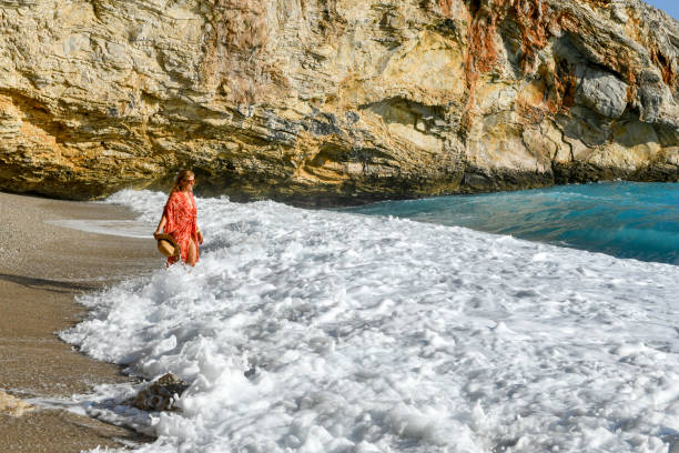 istock Woman walking among the waves. 1164031718