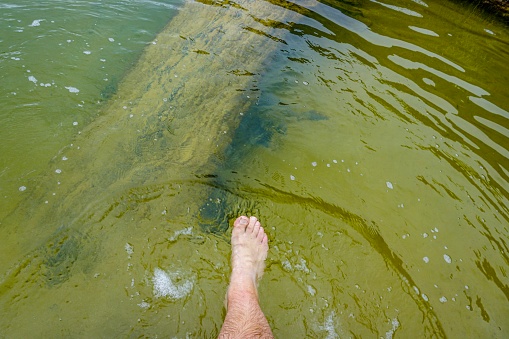 A foot in a small river in Australia near the Great Ocean Road