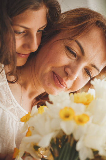 istock Mother and daughter enjoying spring flowers 1164032725
