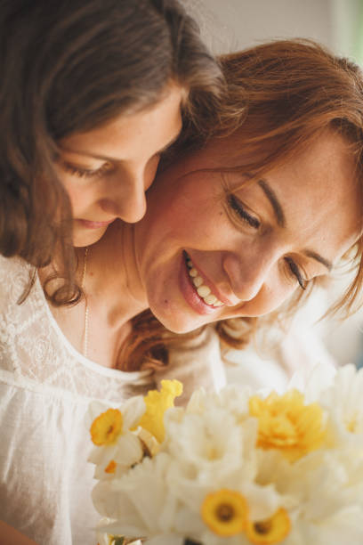 istock Mother and daughter enjoying spring flowers 1164032735
