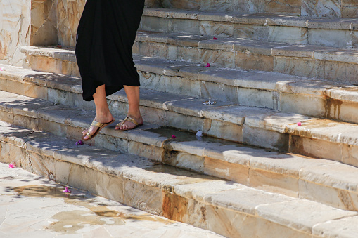 Close up women foot walking down stone stairs in tourist resorts