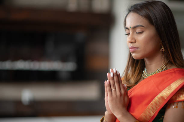 istock A Young and Attractive Indian Woman Praying 1164033438