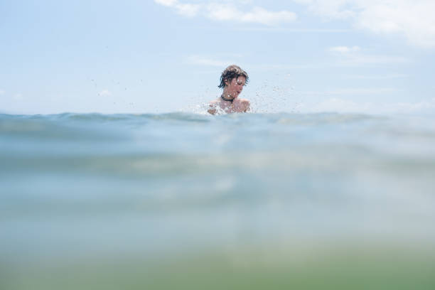 istock Splashing and playing in beautiful ocean waters 1164033482