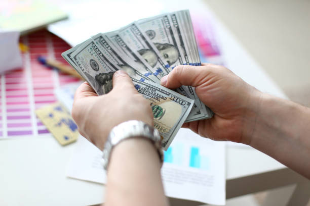 istock Male hands counting money from huge pack 1164033501