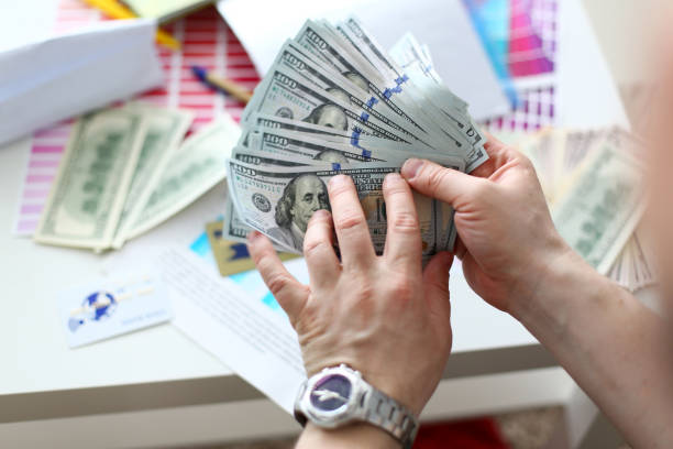 istock Male hands counting money from huge pack 1164033503