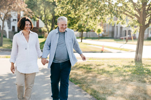 istock Senior couple walking in the park 1164033644