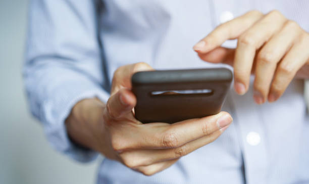 istock close up young man hand holding smartphone device for searching internet website or playing on application in relaxing time , millennial lifestyle people concept 1164034006