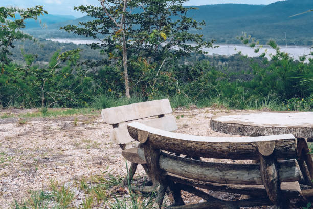 istock wooden bench on mountain hill with river view 1164034061