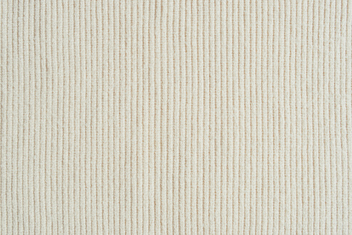 Beige knitted fabric background.
