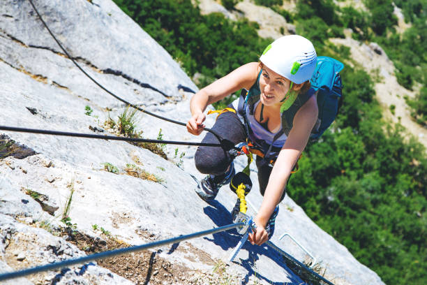 istock Woman climbing mountain. 1164034149