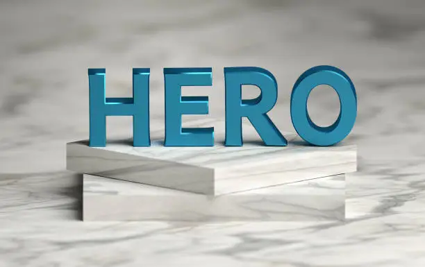 Photo of Large bold blue word HERO standing on marble pedestal