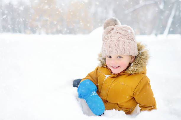 istock Little boy having fun in the snow 1164035923