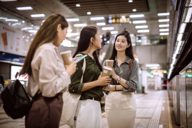 istock Beautiful Asian friends waiting for subway train 1164036055