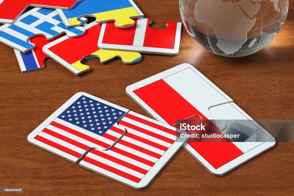 America and Poland Flags in puzzle puzzle with the national flag of America and Poland on wooden table Poland Stock Photo