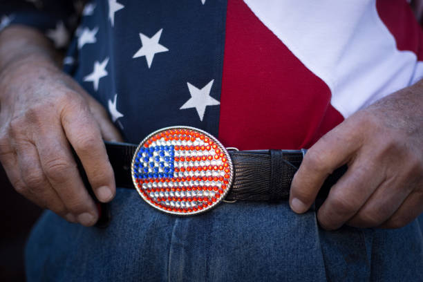 Man's Hands Holding Onto His US Flag Belt, Close-Up