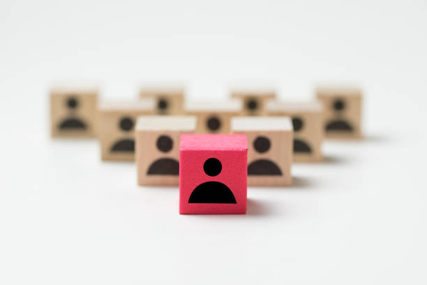 Leadership concept using red people icon cube among other cubes stock photo