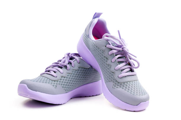 istock Unbranded purple running shoes on a white background 1164043431