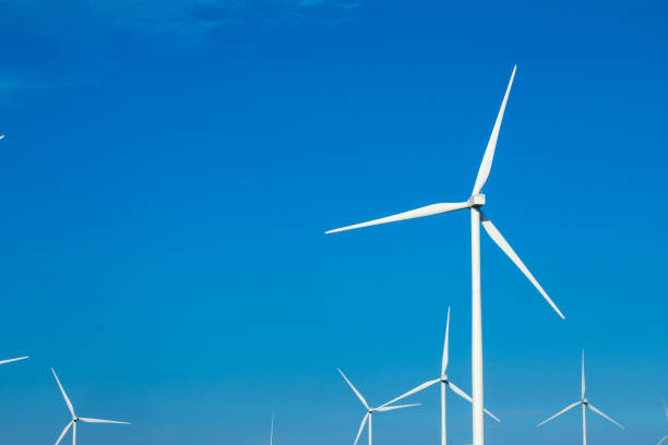 istock green meadow with Wind turbines generating electricity 1164045299