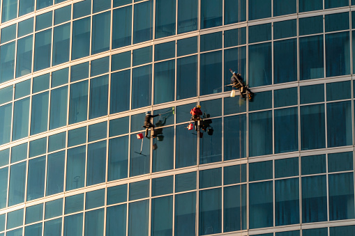 The window washers on the skyscrapers at work,