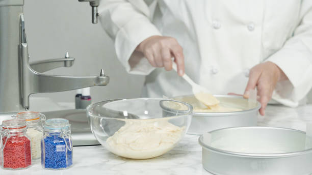 istock Puring cake batters into a cake pan to bake a three-layer vanilla cake. 1164055996
