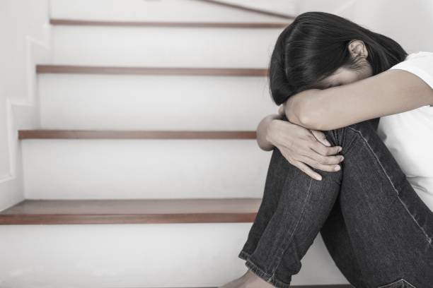 istock The depression woman alone sitting on staircase. 1164058078