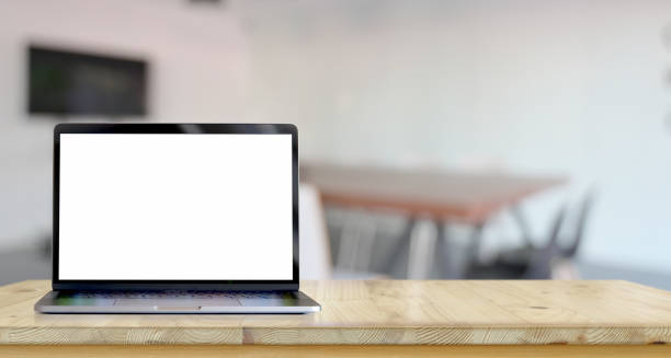 istock Open blank screen laptop on wooden table 1164059886