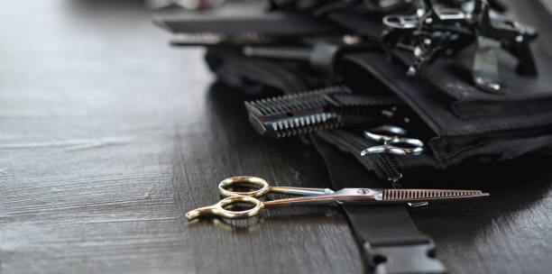 Professional hairdresser's tool Close-up view of hairdresser's tool on black wooden table hairdresser photos stock pictures, royalty-free photos & images