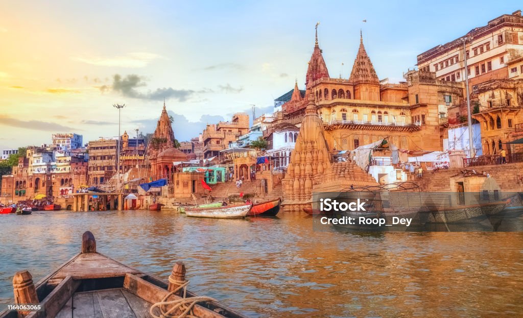 Varanasi ancient city architecture at sunset as viewed from a boat on river Ganges Varanasi ancient city architecture with river ghat at sunset with as seen from a boat on the river Ganges Varanasi Stock Photo