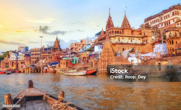 Varanasi Ancient City Architecture At Sunset As Viewed From A Boat On River Ganges Stock Photo - Download Image Now