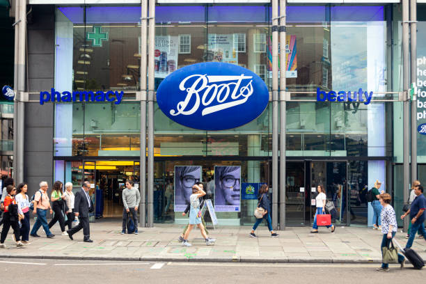 People walking in front of the Boots pharmacy in London London, UK - July 18, 2019: People walking in front of the Boots pharmacy on Oxford Street, London. Oxford Street is one of the most famous shopping streets in the London. boot stock pictures, royalty-free photos & images