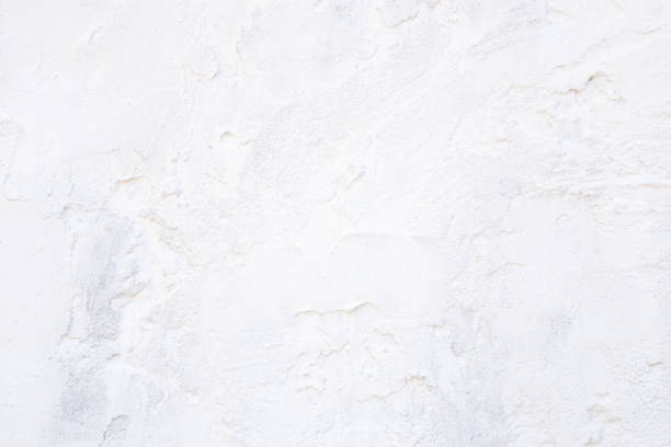 istock Abstract empty light white construction background with texture of stucco building material on the surface of a rustic vintage kitchen wall with copy space 1164064898