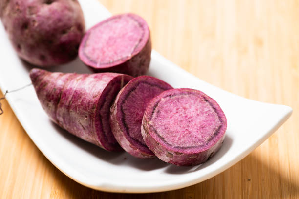 istock Sweet Potatoes Purple Colored on Table 1164065218