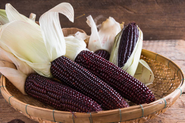 Purple corn on wooden background stock photo