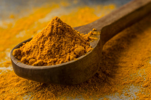 istock Turmeric powder in wood spoon 1164065459