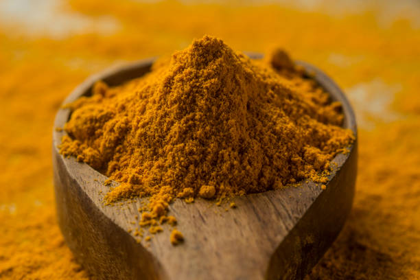 istock Turmeric powder in wood spoon 1164066155