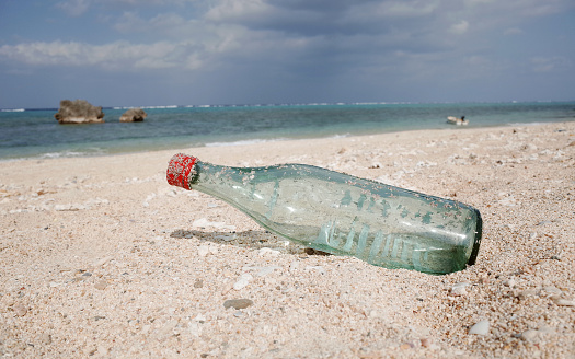 Glass Bottle Garbage on the Sand, Trash on the Beach From Tourist, Pollution Environment, Solve the Problem with Recycle and Responsibility of Human