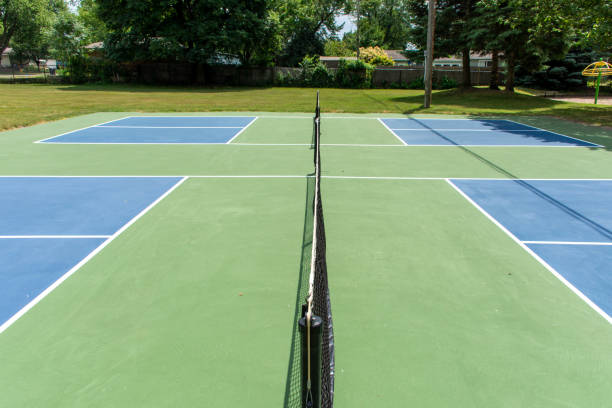 Recreational sport of pickleball court in Michigan, USA looking at an empty blue and green new court at a outdoor park. Middle Court View. stock photo
