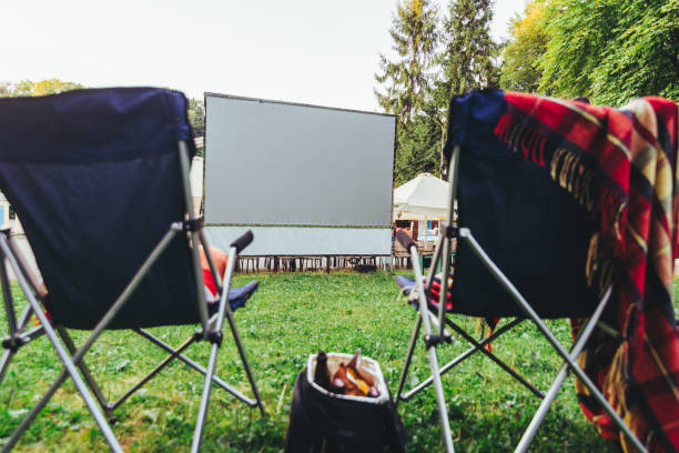 istock open air cinema concept folding chairs in front of big white screen 1164069648