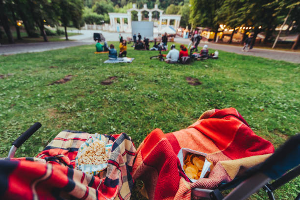 istock two folding chairs with cooling bag with beer and snacks in open air cinema 1164069839