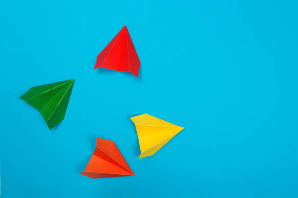 istock Color paper airplanes on blue background. top view 1164072724