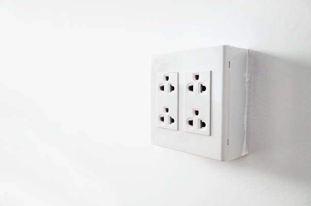 istock Side of Outlet Plug in white room 1164074000